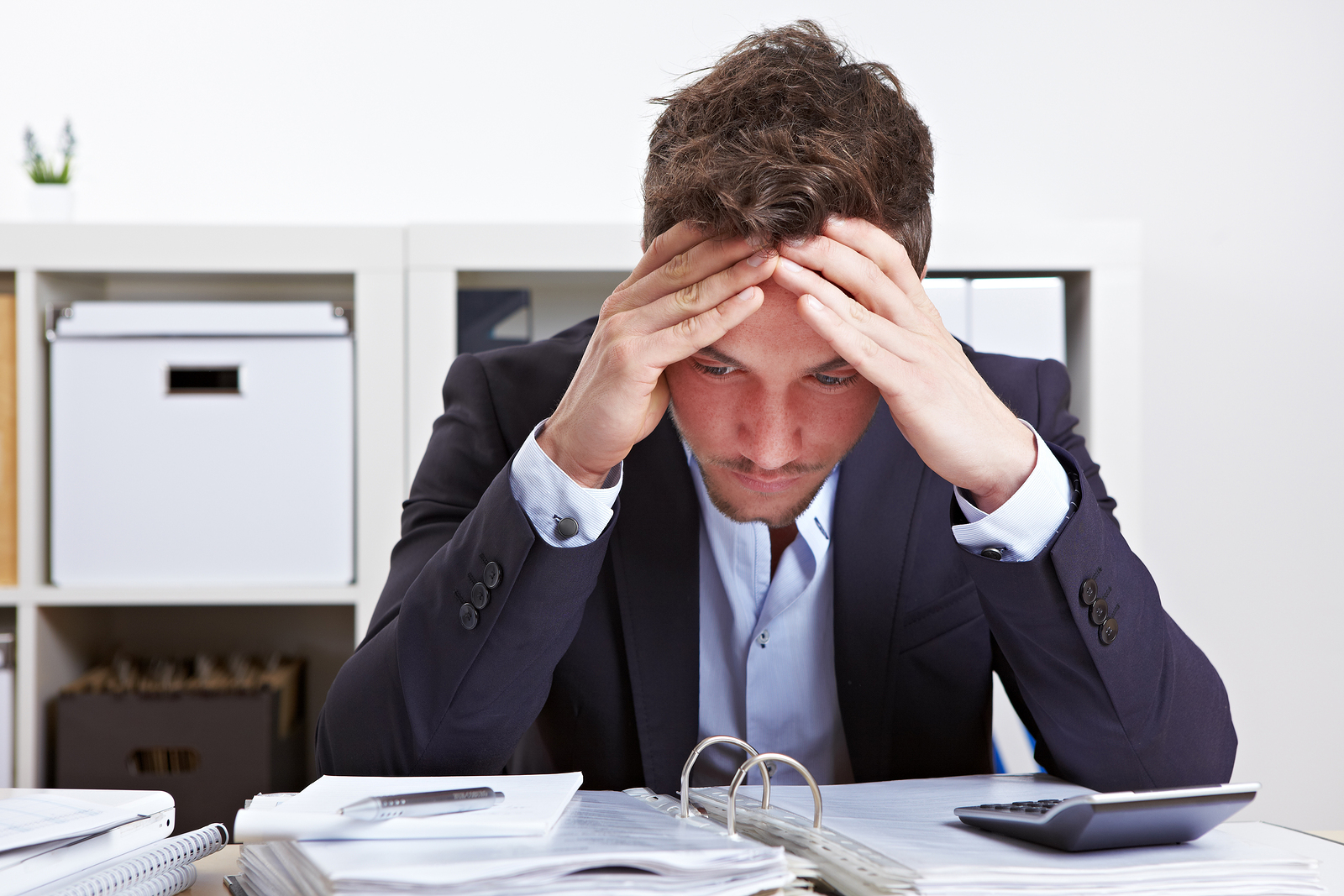 bigstock-Business-man-in-office-with-bu-30357824.jpg